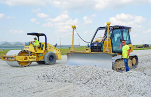 Workers with Hawkeye Enterprises doing paving work near Newport’s airport, known locally as the air base. The area is home to a dozen industries and two state prisons.