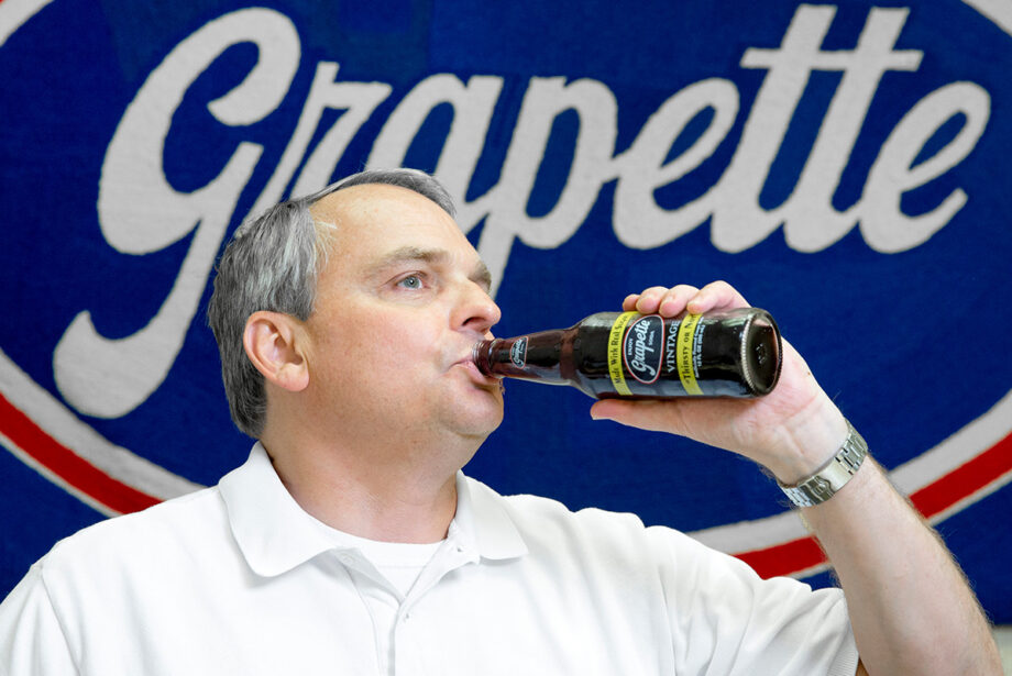 David Rice, vice president and director of marketing at Grapette International, tosses back a signature soda at the Malvern plant.