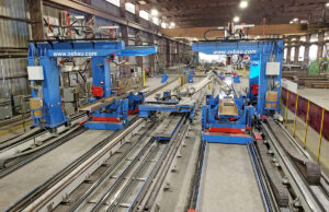 Prospect Steel in Blytheville, a Lexicon company, has “the most automated fit and weld fabrication facility in the world,” CEO Patrick Schueck says. Its double robotic line, seen here, consists of four welding robots and one fitting robot.