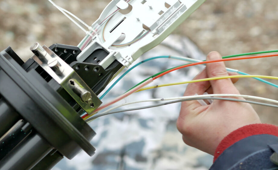 A technician installs fiber optic cables. Little River County, Arkansas has received a $2 million federal grant to build fiber optic cable lines to support broadband infrastructure.&nbsp;
