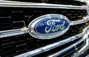 The Ford emblem on the grill of a pickup truck.