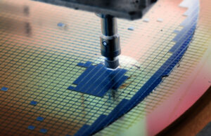 A silicon wafer being placed on a semiconductor device by a die attach machine.&nbsp;