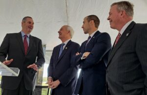 Trex CEO Bryan Fairbanks, left, talks with Arkansas Gov. Asa Hutchinson, center, and Secretary of Commerce Mike Preston, second from righ, at the announcement of a new $400 million Trex facility in Little Rock.&nbsp;