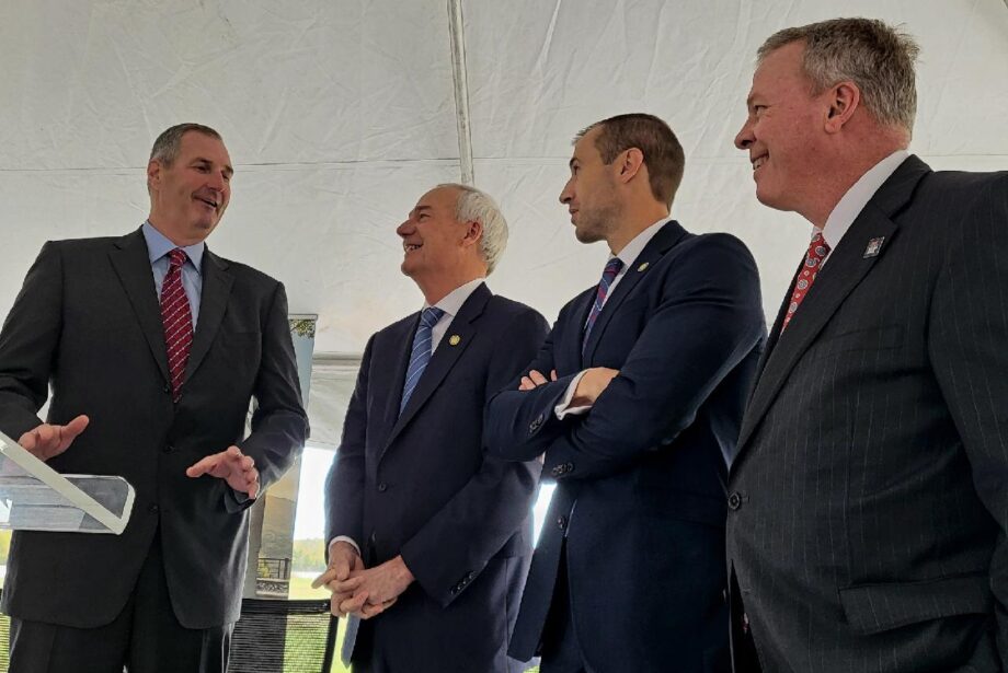 Trex CEO Bryan Fairbanks, left, talks with Arkansas Gov. Asa Hutchinson, center, and Secretary of Commerce Mike Preston, second from righ, at the announcement of a new $400 million Trex facility in Little Rock.&nbsp;