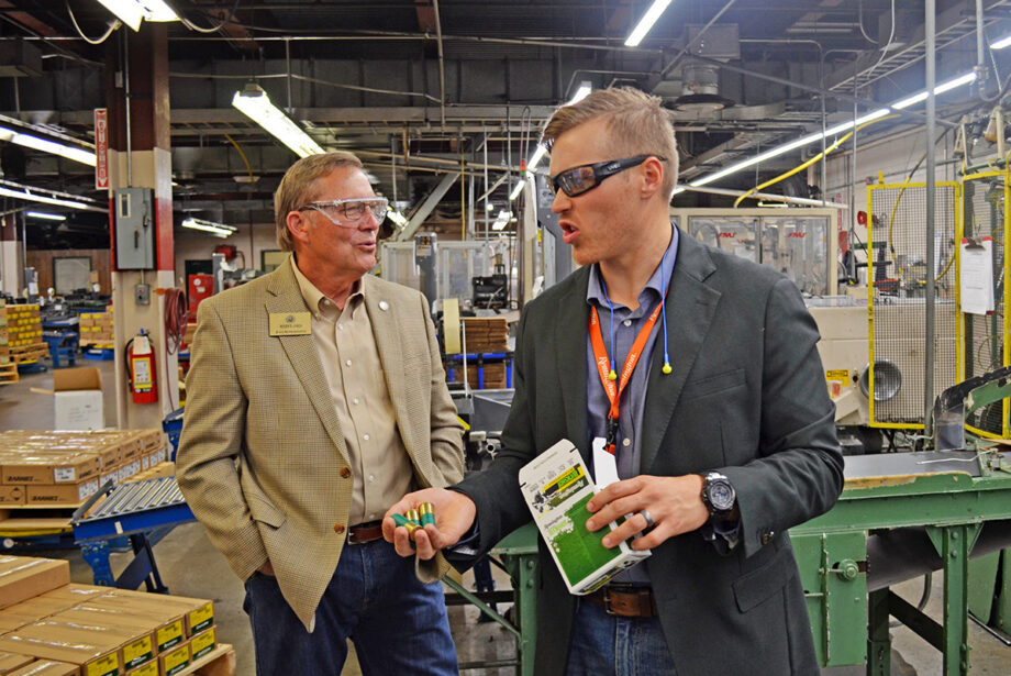 Retired employee state Rep. Roger Lynch speaks with Vista Outdoor spokesman Joel Hodgdon during a tour of the Remington plant in Lonoke.