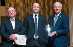 Michael Schrekenhofer (middle) of Leather Brothers Inc. accepts a&nbsp;Governor's Award for Excellence in Global Trade from&nbsp;Rudy Ortiz, chair of the Arkansas District Export Council (left) and Gov. Asa Hutchinson.
