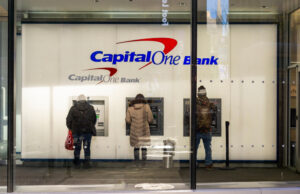 Customers use ATMs at a Capital One Bank branch in New York City in 2019.