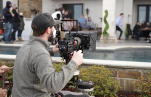 Stone Ward Director of Photography Dustin Jones filming a wide shot in the Sissy’s Log Cabin commercial the Little Rock marketing agency made for the Super Bowl.