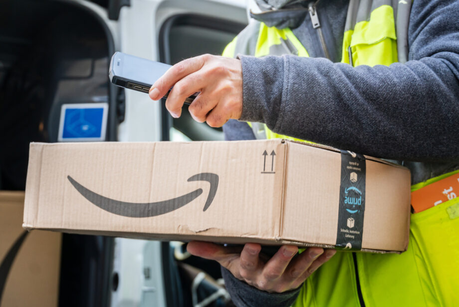 An Amazon Prime delivery agent scans barcodes on boxes