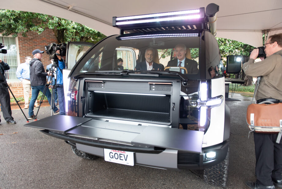 Canoo Inc. CEO Tony Aquila, left, shows Arkansas Gov. Asa Hutchinson the inside of one of the company's electric vehicles during an event at the Governor's Mansion on Feb. 22, 2022.&nbsp;