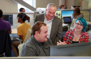 Albert Baker, now chair of UA Little Rock’s Department of Computer Science, works with UA Little Rock students in 2018, when he was a visiting professor.