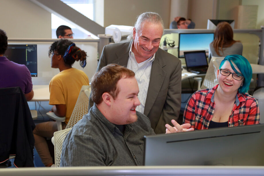 Albert Baker, now chair of UA Little Rock’s Department of Computer Science, works with UA Little Rock students in 2018, when he was a visiting professor.