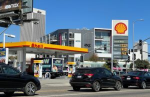 Motorists drive past a Shell gas station in Los Angeles with prices over $7 per gallon in March 2022