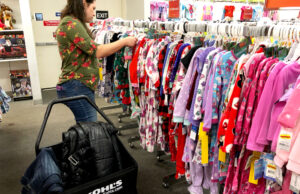 A woman looking through a rack of children's pajamas at a Kohl's store in Sacramento, California