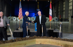 U.S. Steel CEO David Burritt, right, shakes hands with Arkansas Gov. Asa Hutchinson at a groundbreaking ceremony for the company's new $3 billion mill in Osceola on Feb. 8, 2022.