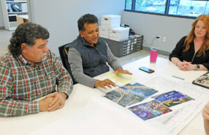 Dr. James Thomas, center, discusses plans for  a $28 million entertainment venue at the former Wild River Country site in North Little Rock. He is flanked by Ronnie Robertson, managing director of Maly Construction, and Angie Perdue, architectural technician at the Conway firm.