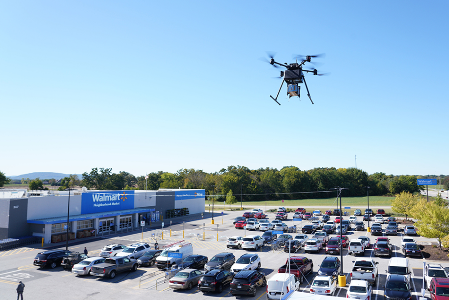 A DroneUp delivery drone in the air above a Walmart location in Farmington, Arkansas