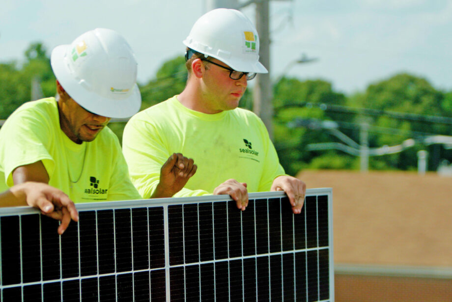 A crew from Seal Solar of North Little Rock installs solar panels at 107 Liquor in Sherwood.