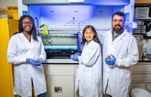 University of Arkansas doctoral student Adedoyin Abe, left, stands next to professor of mechanical engineering Min Zou and senior research assistant Josh Goss.