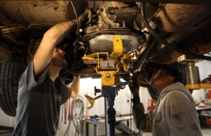 Black River Technical College students examining a vehicle. The college has received a Regional Workforce Grant for its Auto Collision Technology department.