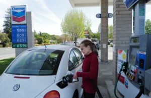 A woman fuels up her vehicle at a gas station in Novato, California, in April 2022