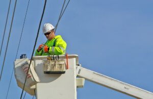 A lineman strings high-speed cable.