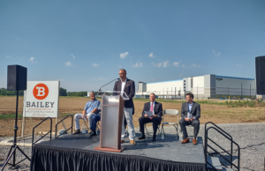 Luke Neville, co-founder and partner at Bluestem Partners of Kansas City, speaks at a groundbreaking ceremony for a warehouse project at the Little Rock Port on July 14, 2022.
