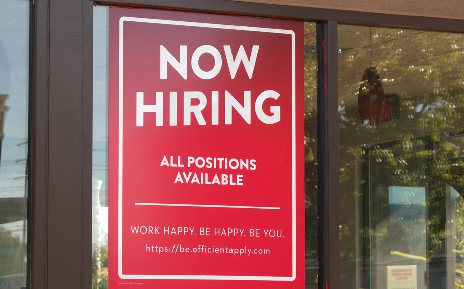 A sign advertising open positions at a restaurant in Vista, California
