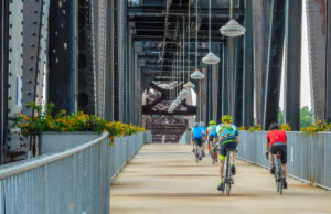 Cyclists cross the Clinton Presidential Park Bridge connecting Little Rock and North Little Rock over the Arkansas River. Housing construction in the Little Rock metro area hit a 14-year high in 2021.