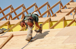 A construction crew working on the roof of a new apartment building in Oregon