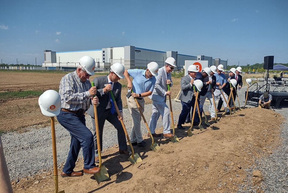 Amazon’s massive distribution center at the Port of Little Rock loomed in the background last month as Bluestem broke ground on its speculative warehouse project, nearly a million SF of space.