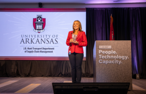 J.B. Hunt President Shelley Simpson announces the newly named J.B. Hunt Transport Department of Supply Chain Management for Walton College to a crowd of employees and University of Arkansas faculty and students.