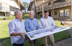 Restaurateurs Jim Keet, left, and his son, Jake, right, look over a rendering of the planned facade update for their future Waldo’s Chicken & Beer location with fellow Breckenridge Village Shopping Center investor Hank Kelley.