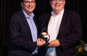 Chip Culpepper, left, principal at MHP/Team SI, presents the PRSA Diamond Award to Arkansas Democrat-Gazette Senior Editor Rex Nelson.