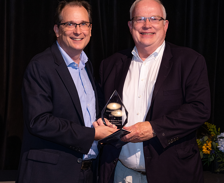Chip Culpepper, left, principal at MHP/Team SI, presents the PRSA Diamond Award to Arkansas Democrat-Gazette Senior Editor Rex Nelson.