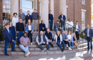 Abaca executives and employees pose for a group photo outside a branch of the North Little Rock Public Library System