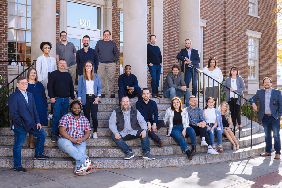 Abaca executives and employees pose for a group photo outside a branch of the North Little Rock Public Library System