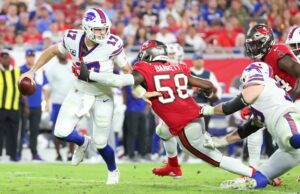 Buffalo Bills quarterback Josh Allen evades Tampa Bay Buccaneers linebacker Shaquil Barrett in a December 2021 NFL game