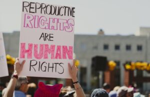 People with protest signs gather during a "Bans Off Our Bodies Rally" in Reno, Nevada in May 2022