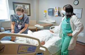 Dr. Shaletha Jones, right, a family medicine doctor and hospitalist at Ouachita County Medical Center, talks with a mock patient as Paige Garcia, a registered nurse, takes vitals. In the fiscal year that ended Sept. 30, surgeries at the hospital were down 34%.