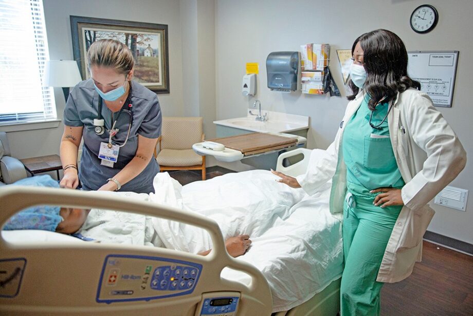Dr. Shaletha Jones, right, a family medicine doctor and hospitalist at Ouachita County Medical Center, talks with a mock patient as Paige Garcia, a registered nurse, takes vitals. In the fiscal year that ended Sept. 30, surgeries at the hospital were down 34%.