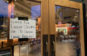 Seattle, Washington, June 19, 2022: Closed for Strike Sign on Starbucks Window at First and Pike protesting Unfair Labor