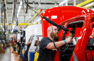 A worker installs an airbag on the assembly line at GM's Chevrolet Silverado and GMC Sierra pickup truck plant in Fort Wayne, Indiana