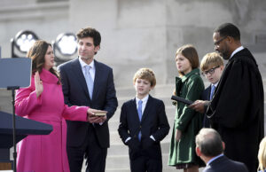 Arkansas Gov.-elect Sarah Huckabee Sanders takes the oath of the office administered by 8th Circuit Court judge Brian Miller on the steps of the Arkansas Capitol with husband Bryan and children Huck, Scarlett and George, Tuesday, Jan. 10, 2023, in Little Rock, Ark.