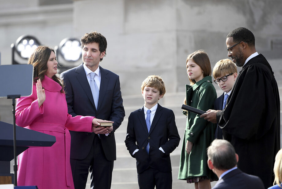 Arkansas Gov.-elect Sarah Huckabee Sanders takes the oath of the office administered by 8th Circuit Court judge Brian Miller on the steps of the Arkansas Capitol with husband Bryan and children Huck, Scarlett and George, Tuesday, Jan. 10, 2023, in Little Rock, Ark.