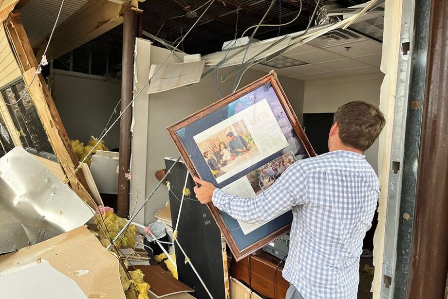 Jake Keet examines tornado damage at the Breckenridge Village shopping center in Little Rock on March 31, 2023