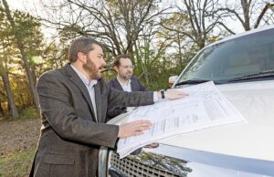 Colliers International Arkansas execs Bradford Gaines, left, and Bill Pendergist talk about development plans at The Middle project in west Little Rock.