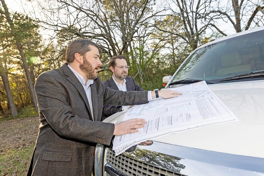 Colliers International Arkansas execs Bradford Gaines, left, and Bill Pendergist talk about development plans at The Middle project in west Little Rock.