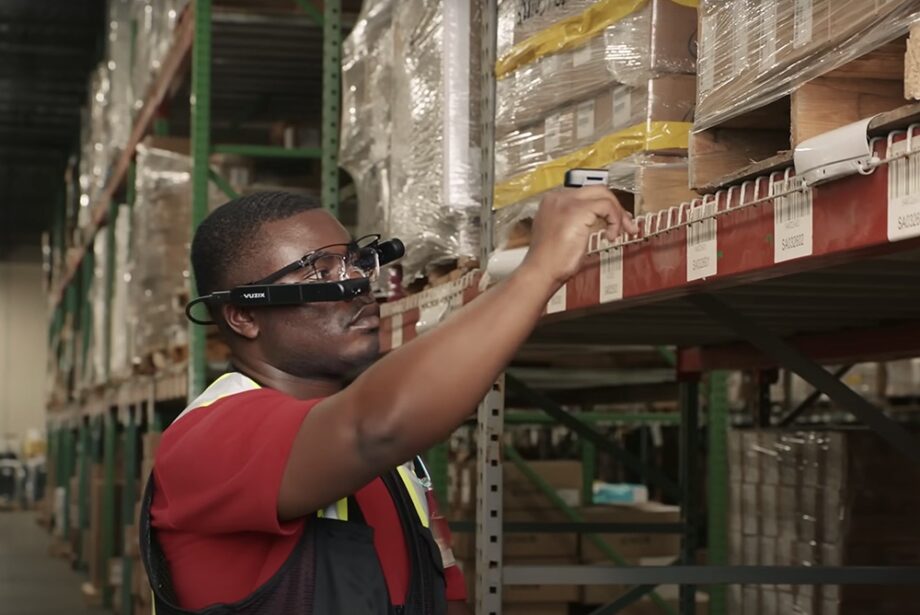 A warehouse worker uses Ox wearable technology to track items in the supply chain.