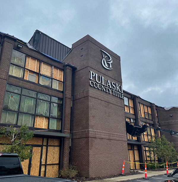 Windows are boarded up at the offices of Pulaski County Title Co. of Little Rock, which suffered damage in the March 31 tornado.